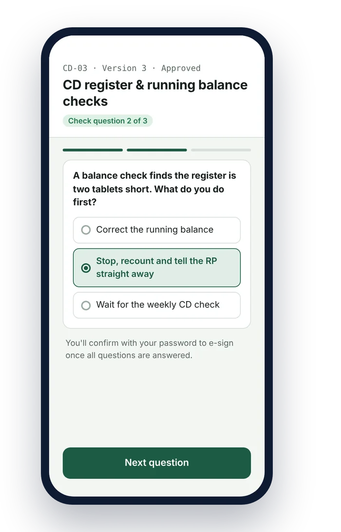 A pharmacy team member answering a check question before e-signing a controlled drugs SOP on a phone